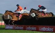 26 April 2023; Fastorslow, right, with JJ Slevin up, jumps the last on their way to winning the Ladbrokes Punchestown Gold Cup, from third place Bravemansgame, left, with Harry Cobden up, during day two of the Punchestown Festival at Punchestown Racecourse in Kildare. Photo by Seb Daly/Sportsfile