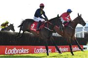 26 April 2023; Fastorslow, left, with JJ Slevin up, and Envoi Allen, right, with Rachael Blackmore up, jump the sixth during the Ladbrokes Punchestown Gold Cup on day two of the Punchestown Festival at Punchestown Racecourse in Kildare. Photo by Seb Daly/Sportsfile