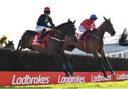 26 April 2023; Fastorslow, left, with JJ Slevin up, and Envoi Allen, right, with Rachael Blackmore up, jump the sixth during the Ladbrokes Punchestown Gold Cup on day two of the Punchestown Festival at Punchestown Racecourse in Kildare. Photo by Seb Daly/Sportsfile