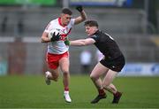 26 April 2023; Jody McDermott of Derry in action against Odhran Murdock of Down during the 2023 EirGrid Ulster U20 Football Championship Final match between Derry and Down at BOX-IT Athletic Grounds in Armagh. Photo by Ben McShane/Sportsfile
