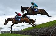 27 April 2023; Clonguile Way, left, with Alex Harvey up, and Mortal, right, with Jody McGarvey up, jump Ruby's Double during the Mongey Communications La Touche Cup Cross Country Steeplechase on day three of the Punchestown Festival at Punchestown Racecourse in Kildare. Photo by Seb Daly/Sportsfile
