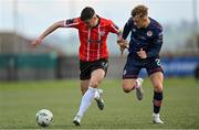 28 April 2023; Cian Kavanagh of Derry City in action against Sam Curtis of St Patrick's Athletic during the SSE Airtricity Men's Premier Division match between Derry City and St Patrick's Athletic at The Ryan McBride Brandywell Stadium in Derry. Photo by Ramsey Cardy/Sportsfile