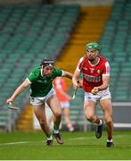 28 April 2023; Ben Cunningham of Cork in action against Ethan Hurley of Limerick during the oneills.com Munster GAA Hurling U20 Championship Round 5 match between Limerick and Cork at TUS Gaelic Grounds in Limerick. Photo by Stephen Marken/Sportsfile