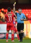 28 April 2023; Referee Ray Matthews shows a yellow card to Matty Smith of Shelbourne during the SSE Airtricity Men's Premier Division match between Shelbourne and Cork City at Tolka Park in Dublin. Photo by Harry Murphy/Sportsfile