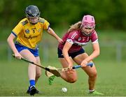29 April 2023; Kate Whyte of Westmeath in action against Grace Geraghty of Roscommon during the Electric Ireland Camogie Minor B All-Ireland Championship Semi Final match between Roscommon and Westmeath at Templeport St. Aidan’s in Corrasmongan, Cavan. Photo by Stephen Marken/Sportsfile
