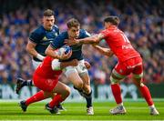 29 April 2023; Garry Ringrose of Leinster is tackled by Dorian Aldegheri and Romain Ntamack of Toulouse during the Heineken Champions Cup Semi Final match between Leinster and Toulouse at the Aviva Stadium in Dublin. Photo by Brendan Moran/Sportsfile