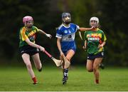 29 April 2023; Kaylee O'Keefe of Laois in action against Aimie Nolan, left, and Eimear Raleigh of Carlow during the Electric Ireland Camogie Minor B All-Ireland Championship Semi-Final match between Carlow and Laois at Banagher in Offaly. Photo by Tom Beary/Sportsfile