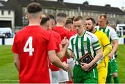 29 April 2023; St Michael's AFC captain Jimmy Carr leads his side during the hand shakes before the FAI Junior Cup Final match between St Michael’s AFC and Newmarket Celtic at Jackman Park in Limerick. Photo by Seb Daly/Sportsfile