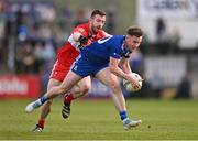 29 April 2023; Karl O'Connell of Monaghan in action against Niall Loughlin of Derry during the Ulster GAA Football Senior Championship Semi Final match between Derry and Monaghan at O’Neills Healy Park in Omagh, Tyrone. Photo by Ben McShane/Sportsfile