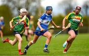 29 April 2023; Kaylee O'Keefe of Laois in action against Roisin Carroll, left, Aislinn Joyce of Carlow during the Electric Ireland Camogie Minor B All-Ireland Championship Semi-Final match between Carlow and Laois at Banagher in Offaly. Photo by Tom Beary/Sportsfile