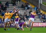 29 April 2023; Jack O'Connor of Wexford scores his side a point despite the efforts of Scott Walsh of Antrim during the Leinster GAA Hurling Senior Championship Round 2 match between Wexford and Antrim at Chadwicks Wexford Park in Wexford. Photo by Tyler Miller/Sportsfile