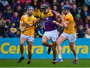 29 April 2023; Jack O'Connor of Wexford in action against Scott Walsh of Antrim, left, and Keelan Molloy during the Leinster GAA Hurling Senior Championship Round 2 match between Wexford and Antrim at Chadwicks Wexford Park in Wexford. Photo by Tyler Miller/Sportsfile