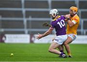 29 April 2023; Oisin Foley of Wexford loses possession against Michael Bradley of Antrim during the Leinster GAA Hurling Senior Championship Round 2 match between Wexford and Antrim at Chadwicks Wexford Park in Wexford. Photo by Tyler Miller/Sportsfile