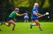 29 April 2023; Lucy Conroy of Laois in action against Holly Wall Murphy of Carlow during the Electric Ireland Camogie Minor B All-Ireland Championship Semi-Final match between Carlow and Laois at Banagher in Offaly. Photo by Tom Beary/Sportsfile