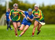 29 April 2023; Susie Delaney of Laois in action against Aislinn Joyce, left, and Eimear Raleigh of Carlow during the Electric Ireland Camogie Minor B All-Ireland Championship Semi-Final match between Carlow and Laois at Banagher in Offaly. Photo by Tom Beary/Sportsfile