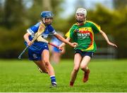 29 April 2023; Kaylee O'Keefe of Laois in action against Roisin Carroll of Carlow during the Electric Ireland Camogie Minor B All-Ireland Championship Semi-Final match between Carlow and Laois at Banagher in Offaly. Photo by Tom Beary/Sportsfile