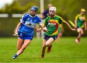 29 April 2023; Kaylee O'Keefe of Laois in action against Roisin Carroll of Carlow during the Electric Ireland Camogie Minor B All-Ireland Championship Semi-Final match between Carlow and Laois at Banagher in Offaly. Photo by Tom Beary/Sportsfile
