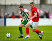 29 April 2023; Eoin Hayes of Newmarket Celtic in action against Sean Murphy of St Michael's AFC during the FAI Junior Cup Final match between St Michael’s AFC and Newmarket Celtic at Jackman Park in Limerick. Photo by Seb Daly/Sportsfile