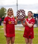 30 April 2023; Joint captain Oilibhia Farley, left, and Áine Cunningham of Tyrone celebrate with the trophy after their side's victory in the Electric Ireland Camogie Minor C All-Ireland Championship Shield Final match between Donegal and Tyrone at Tír na nÓg Randalstown in Antrim. Photo by Stephen Marken/Sportsfile