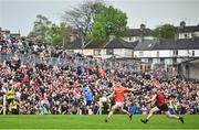 30 April 2023; Rian O'Neill of Armagh kicks at goal under pressure from Niall McParland of Down during the Ulster GAA Football Senior Championship Semi Final match between Armagh and Down at St Tiernach’s Park in Clones, Monaghan. Photo by Ramsey Cardy/Sportsfile