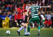 1 May 2023; Colm Whelan of Derry City in action against Lee Grace of Shamrock Rovers during the SSE Airtricity Men's Premier Division match between Derry City and Shamrock Rovers at The Ryan McBride Brandywell Stadium in Derry. Photo by Ramsey Cardy/Sportsfile