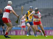 6 May 2023; James Friel of Derry, under pressure from Cormac Mulry of Roscommon, passes to team mate Callum O'Kane during the GAA Hurling All-Ireland U20 B Championship Final match between Derry and Roscommon at Croke Park in Dublin. Photo by Ray McManus/Sportsfile