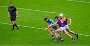 6 May 2023; Danny Sutcliffe of Dublin is tackled by Wexford players Liam Óg McGovern and Oisin Foley, right, under the watchful eye of referee Thomas Walsh during the Leinster GAA Hurling Senior Championship Round 3 match between Dublin and Wexford at Croke Park in Dublin. Photo by Ray McManus/Sportsfile