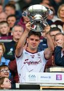 7 May 2023; Jodie Joyce, a daughter of manager Padraic Joyce, bottom left, looks on as Seán Kelly, the Galway captain, lifts the Nestor Cup after the Connacht GAA Football Senior Championship Final match between Sligo and Galway at Hastings Insurance MacHale Park in Castlebar, Mayo. Photo by Ray McManus/Sportsfile