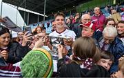 7 May 2023; Galway captain Seán Kelly celebrates with the Nestor Cup as supporters look for autographs after the Connacht GAA Football Senior Championship Final match between Sligo and Galway at Hastings Insurance MacHale Park in Castlebar, Mayo. Photo by Brendan Moran/Sportsfile