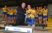 7 May 2023; Brian Molloy, incoming President of the Camogie Association, presents the cup to Mairead Lohan of Roscommon after the Electric Ireland Minor B All-Ireland Championship Final match between Laois and Roscommon at St. Brendan’s Park in Birr, Offaly. Photo by Tom Beary/Sportsfile