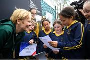 10 May 2023; Participants from Scoil Treasa Naofa, Donore Avenue, Dublin, from left, Tianna Adeboye, Maisie Barrett and Jayda Fitzgerald read a poem to Republic of Ireland manager Vera Pauw during a grassroots girls schools blitz, part of the FIFA Women’s World Cup Trophy Tour in Dublin, at Irishtown Stadium in Dublin. The FIFA Women’s World Cup Trophy Tour began in February and is visiting all 32 of the tournament’s participating nations – more countries than ever before! The tour is ‘Going Beyond’ to inspire people of all ages to get excited about the FIFA Women’s World Cup Australia & New Zealand 2023. Photo by Stephen McCarthy/Sportsfile