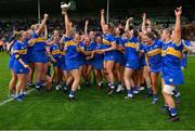 13 May 2023; The Tipperary players join with Mairead Eviston as she celebrates with the cup after the Munster Senior Camogie Championship Final between Clare and Tipperary at FBD Semple Stadium in Thurles, Tipperary. Photo by Ray McManus/Sportsfile