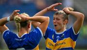 13 May 2023; The Tipperary joint captains Clodagh Quirke, left, and Karen Kennedy adjust their hair before collecting the cup after the Munster Senior Camogie Championship Final between Clare and Tipperary at FBD Semple Stadium in Thurles, Tipperary. Photo by Ray McManus/Sportsfile