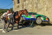 13 May 2023; Eamonn Kelly and Conor Mohan of Ireland pose with a horse as a mechanic fixes their Hyundai i20 N during day three of the FIA World Rally Championship Portugal in Cantelaes, Portugal. Photo by Philip Fitzpatrick/Sportsfile