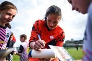 13 May 2023; Anne-Marie Ulliac of Treaty United signs autographs for young supporters after the SSE Airtricity Women's Premier Division match between Treaty United and Peamount United at Markets Field in Limerick. Photo by Tom Beary/Sportsfile