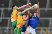 13 May 2023; Lorcan McGee, left, and Donal Gallagher of Donegal in action against Eanna Ward and Odhran Madden, right, of Cavan during the Ulster GAA Minor Football Championship Quarter-Final match between Cavan and Donegal at Kingspan Breffni in Cavan. Photo by Stephen McCarthy/Sportsfile