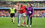13 May 2023; Munster captain Peter O'Mahony is congratulated by a Munster supporter as he leaves the pitch with Munster communications manager Fiona Murphy after the United Rugby Championship Semi-Final match between Leinster and Munster at the Aviva Stadium in Dublin. Photo by Brendan Moran/Sportsfile
