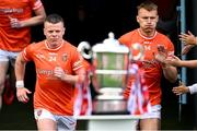 14 May 2023; Armagh joint-captains Aidan Nugent, left, and Rian O'Neill run past the Anglo Celt cup before the Ulster GAA Football Senior Championship Final match between Armagh and Derry at St Tiernach’s Park in Clones, Monaghan. Photo by Ramsey Cardy/Sportsfile