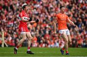 14 May 2023; Brendan Rogers of Derry celebrates scoring a point as Shane McPartlan of Armagh looks on during the Ulster GAA Football Senior Championship Final match between Armagh and Derry at St Tiernach’s Park in Clones, Monaghan. Photo by Harry Murphy/Sportsfile
