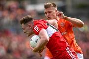 14 May 2023; Ethan Doherty of Derry in action against Rian O'Neill of Armagh during the Ulster GAA Football Senior Championship Final match between Armagh and Derry at St Tiernach’s Park in Clones, Monaghan. Photo by Ramsey Cardy/Sportsfile