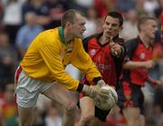 12 June 2004; James Clarke, Carlow goalkeeper is tackled by Down's Daniel Hughes. Bank of Ireland Football Championship Qualifier, Round 1, Carlow v Down, Dr. Cullen Park, Carlow. Picture credit; Damien Eagers / SPORTSFILE