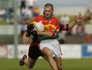12 June 2004; Johnny Kavanagh, Carlow, in action against Ronan Murtagh, Down. Bank of Ireland Football Championship Qualifier, Round 1, Carlow v Down, Dr. Cullen Park, Carlow. Picture credit; Damien Eagers / SPORTSFILE