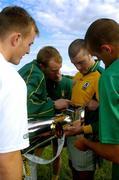 21 June 2004; Meath players, from l to r, Joe Sheridan, Damien Byrne, Niall Kelly and Charles McCarthy take a close look at the Rugby Superleague Trophy before a Meath football and Bradford Bulls Rugby League training session. Dalgan Park, Navan, Co. Meath. Picture credit; Damien Eagers / SPORTSFILE