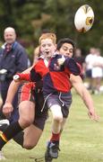 22 June 2004; Philip Holloway, age 8, Coolmine R.F.C, leaves Shon Tayne Hape, Bradford Bulls, trailing during a Bradford Bulls training and skills session in the grounds of Blackrock college, Dublin. Picture credit; Brian Lawless / SPORTSFILE