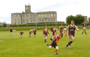 22 June 2004; Matthew Dempsey, age 9, Coolmine R.F.C, attempts to go past the challenge of Stuart Fielden, Bradford Bulls, during a Bradford Bulls training and skills session in the grounds of Blackrock college, Dublin. Picture credit; Brian Lawless / SPORTSFILE