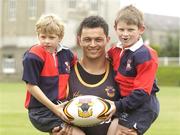 22 June 2004; Robbie Paul, captain of the Bradford Bulls, with Andrew McCabe, left, and Jack Barrett, Coolmine R.F.C, both age 9, during a Bradford Bulls training and skills session in the grounds of Blackrock college, Dublin. Picture credit; Brian Lawless / SPORTSFILE