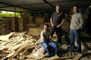 24 June 2004; Hurling Matters. As the latest Guinness advertising campaign for the Hurling Championship says &quot;It's part of what we are&quot; and it certanly is in this household. Pictured with their father Bernie are Ben, left, and Jerry O'Connor of Cork concentrating on hurling matters off the pitch, as they carve out a hurley in advance of this weekend's Guinness Munster Hurling Final between Cork and Waterford. Picture credit; Brendan Moran / SPORTSFILE