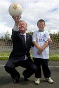 24 June 2004; At the announcement of the allocation of 2 million euro from the Irish Sports Council to the F.A.I. for 2004 aimed at supporting their overall Development Programme were the Minister for Arts, Sport and Tourism, Mr John O'Donoghue T.D., and Graham Murphy, from O'Devaney Gardens, aged 8. O'Devaney Gardens, Dublin. Picture credit; Damien Eagers / SPORTSFILE
