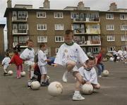 24 June 2004; Local children practice their football skills prior to the announcement of the allocation of 2 million euro from the Irish Sports Council to the F.A.I. for 2004 aimed at supporting their overall Development Programme. O'Devaney Gardens, Dublin. Picture credit; Damien Eagers / SPORTSFILE