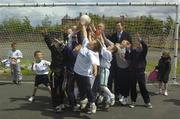 24 June 2004; FAI Technical Director, Packie Bonner, right,  John O'Donoghue T.D., centre, The Minister for Arts, Sport and Tourism, and Pat O'Neill, Chairperson of the Irish Sports Council, hidden, watch as local children play football at the announcement of the allocation of 2 million euro from the Irish Sports Council to the F.A.I. for 2004 aimed at supporting their overall Development Programme. O'Devaney Gardens, Dublin. Picture credit; Damien Eagers / SPORTSFILE